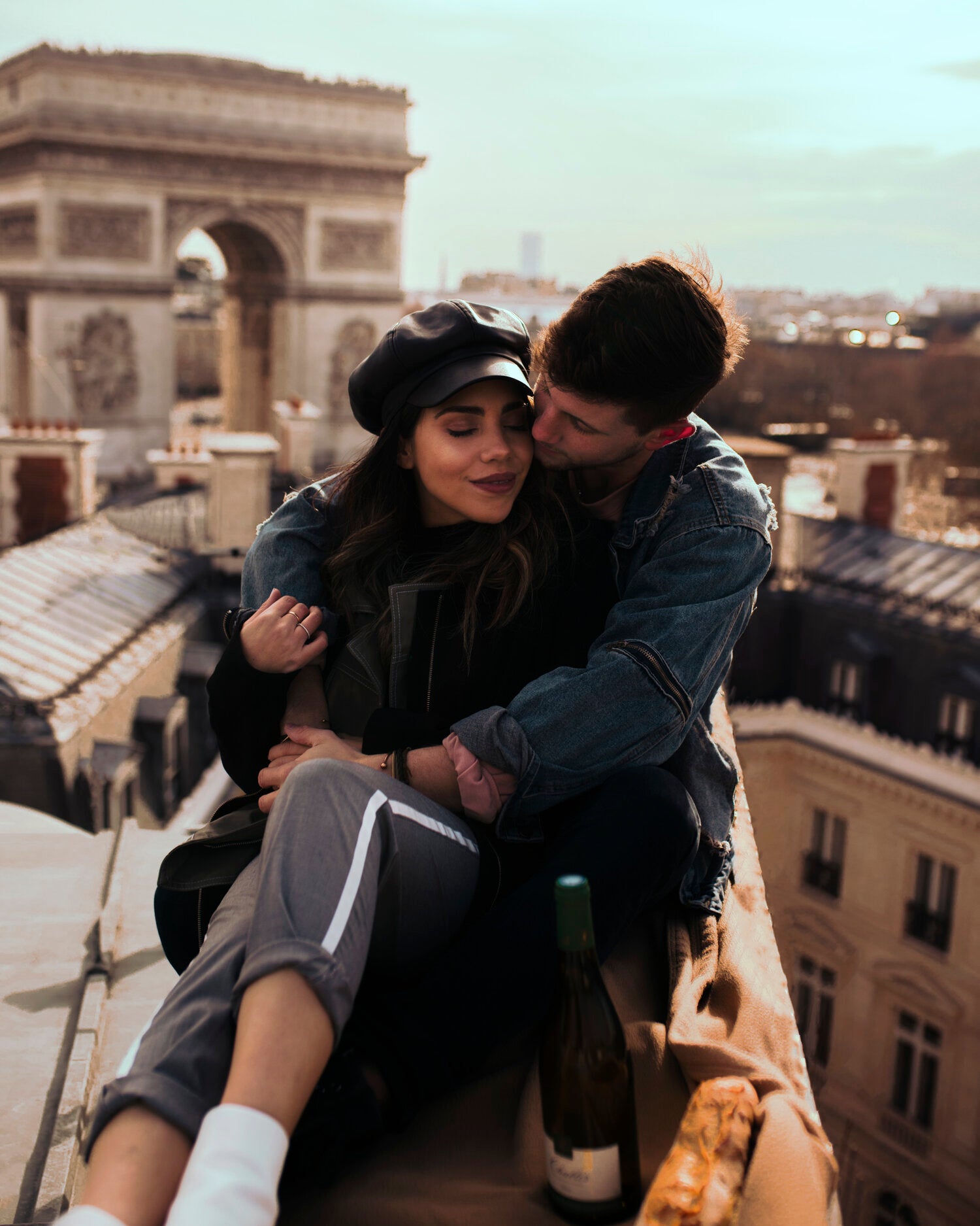 WhatTheChic and Lost LeBlanc on rooftop in Paris with Arc de Triomphe behind