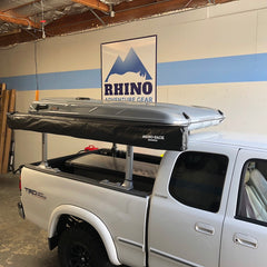 toyota tundra pickup with grey james baroud evasion xxl roof top tent and rhino rack batwing awning installed on thule xsporter bedrack in San Francisco CA