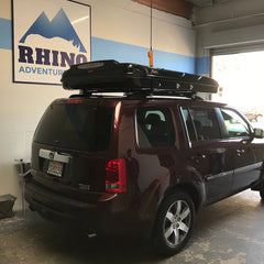 rear 3/4 view of 2014 honda pilot with newly installed james baroud discovery roof top tent at rhino adventure gear showroom in Richmond, CA