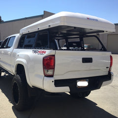 3rd Gen Toyota Tacoma with CBI Overland Bedrack and iKamper Skycamp 4x v2 Roof Top Tent installed at Rhino Adventure Gear California