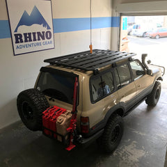 custom 80 series land cruiser with newly installed Rhino Rack Pioneer Platform Rack System shown in Rhino Adventure Gear Showroom in SF, CA