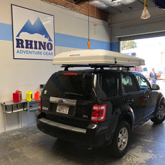 ford escape SUV with Rhino Rack Roof Rack and iKamper Roof Top Tent installed at Rhino Adventure Gear in California
