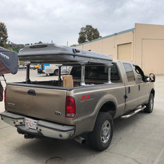 Ford F250 with Thule Xsporter Bed Rack System and James Baroud Evasion Roof Top Tent installed at Rhino Adventure Gear in California