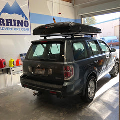 Honda Pilot with Custom Rhino Rack Roof Rack System and black iKamper Skycamp Roof Top Tent installed at Rhino Adventure Gear in California
