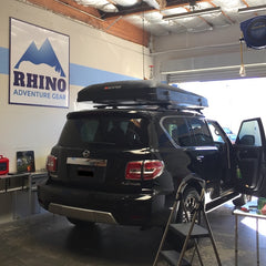 black Nissan Armada ikamper roof top tent installation at San Francisco Overland Outfitter