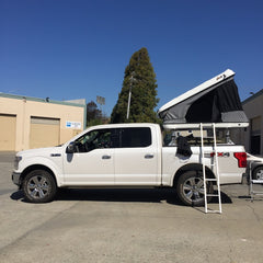 white Ford F-150 with James Baroud Roof Top Tent installed on Thule Bedrack in San Francisco