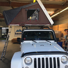 white Jeep JKU with ikamper roof top tent installed on KMS roof rack