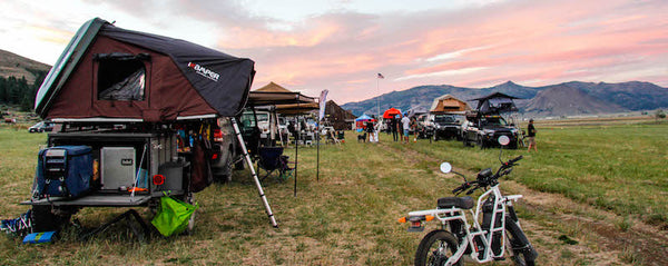 campground full of cars with roof top tents on top