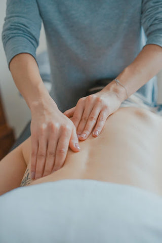 hands massage a bare back