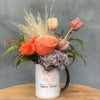 Roots in Rochester mug with flowers