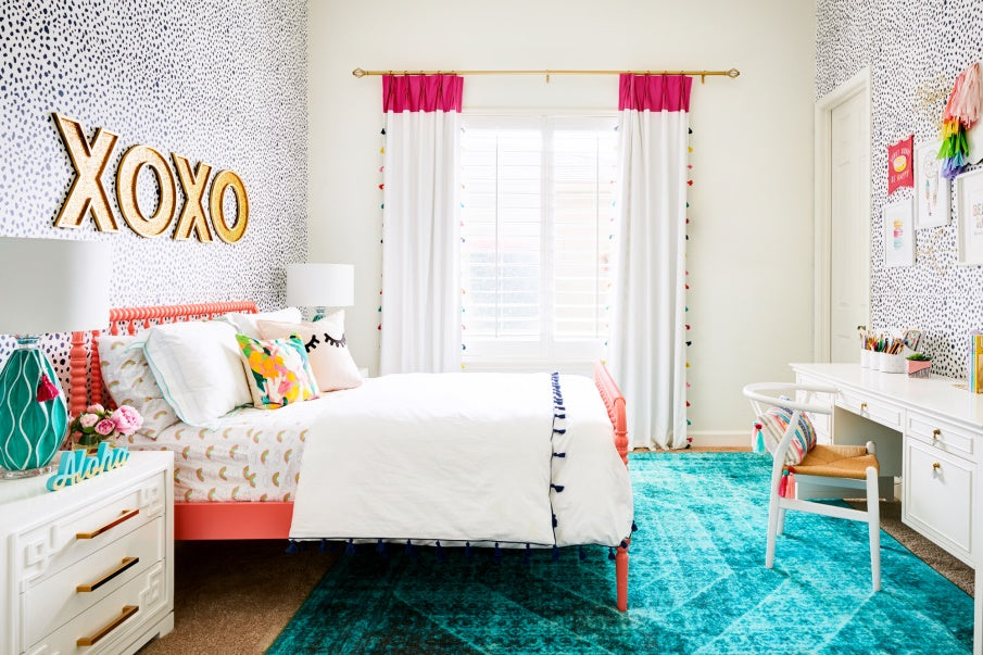 bedroom with colorful and vibrant window dressing