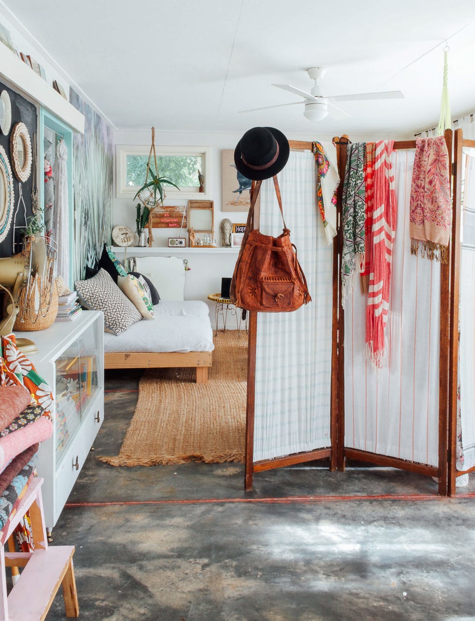bohemian wander inspired home filled with travel mementos and a room divider screen