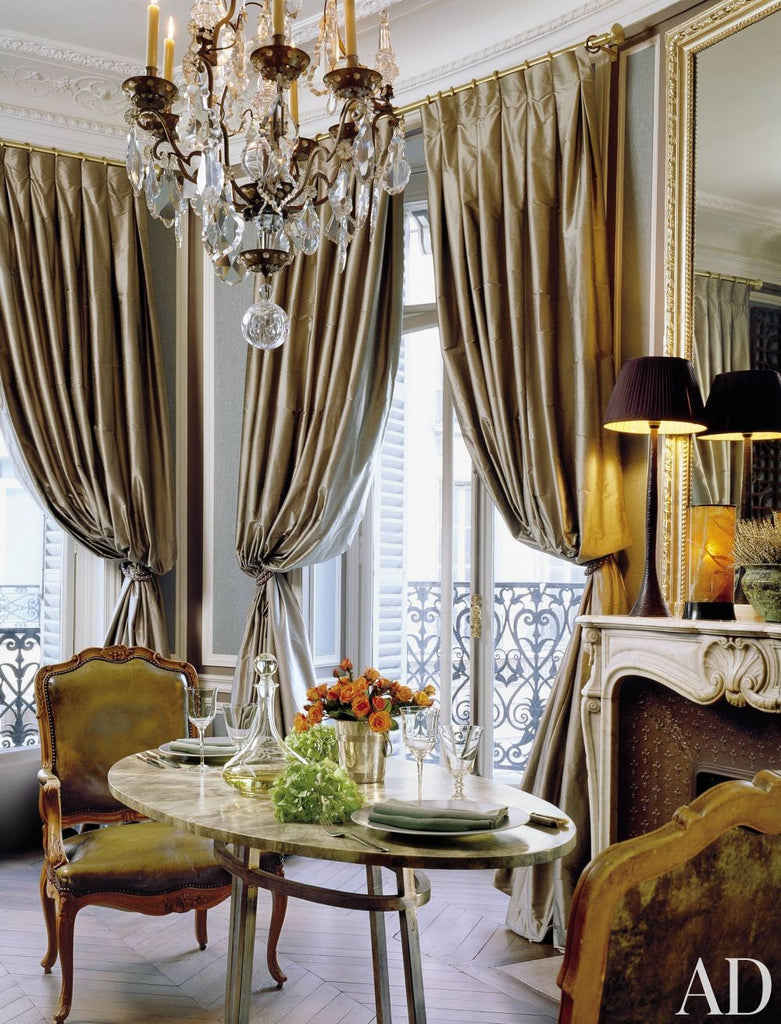 flamboyant french dining area with gold curtains and chandelier