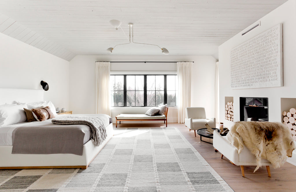 large modern cosy white bedroom with wrought iron curtain rods and white curtains