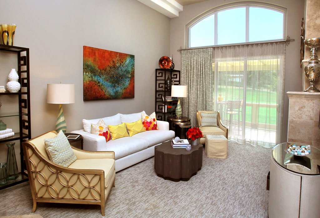 living room with modern art gold finishes and detailed curtain finials by helser brothers