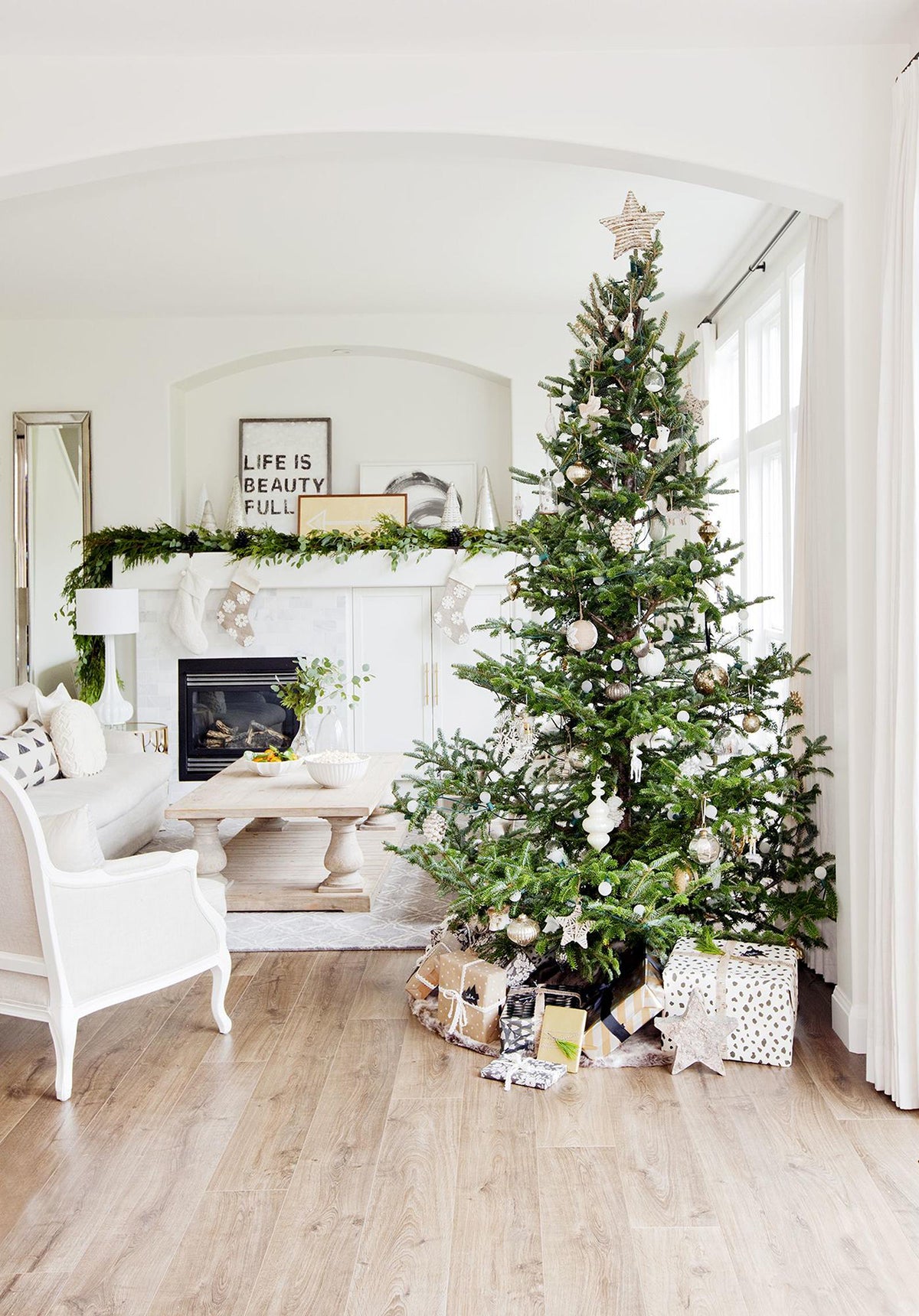 white interior with green Christmas tree and metallic curtain rod brackets