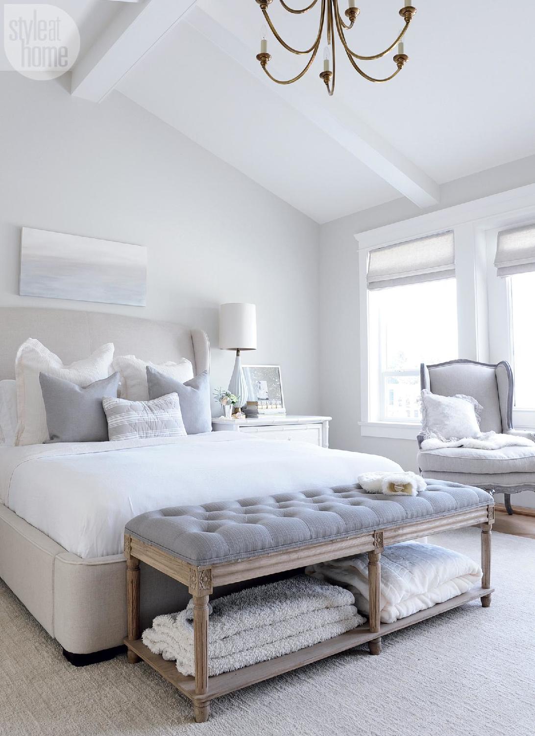 wrought iron drapery rod in a silver bedroom with light walls