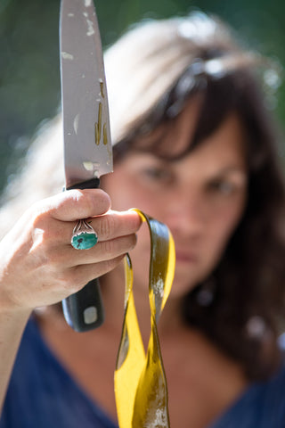 Sealand Gear Ambassador Roushanna Gray holding up a piece of seaweed