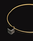 Black glass cube on gold necklace