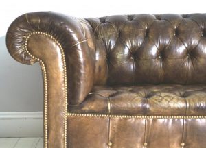 close up of the antique brown leather chesterfield sofa
