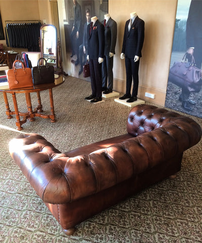 manquins next to a chesterfield sofa