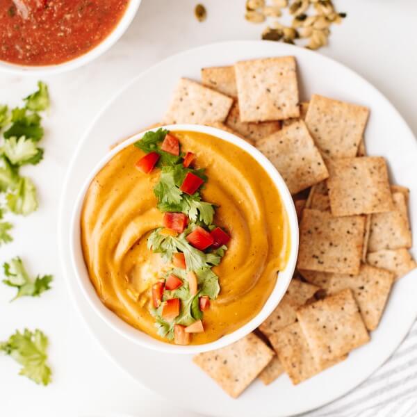 vegan queso dip made with cashew pulp next to crackers