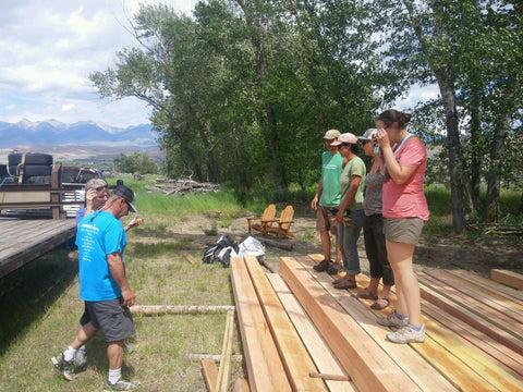 Friends help Sweet Belly Farm unload Timbers