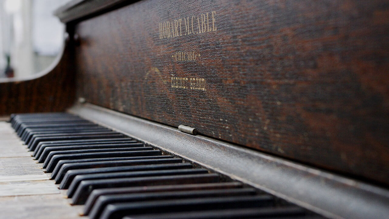 dust piano closeup without keyboard lid
