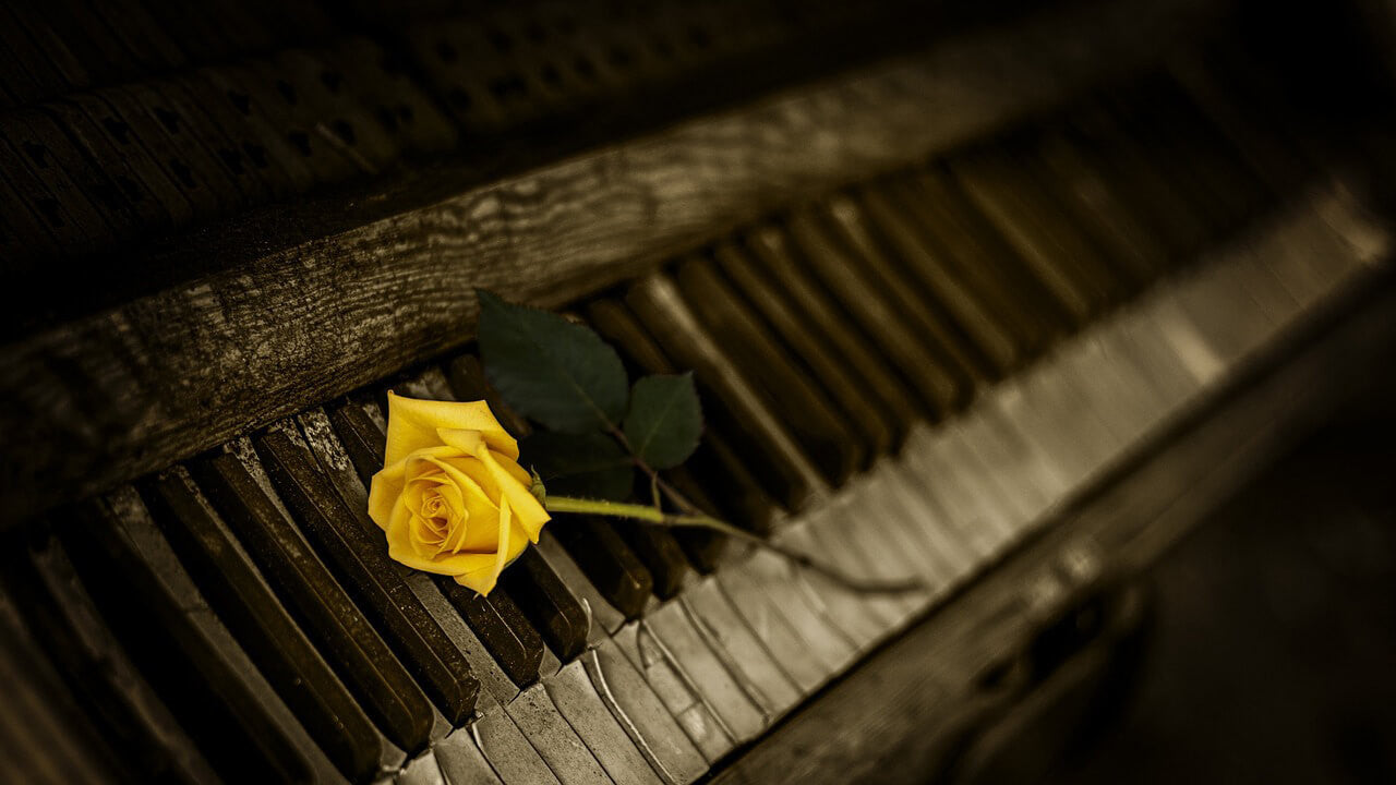 Old and damaged piano without key cover