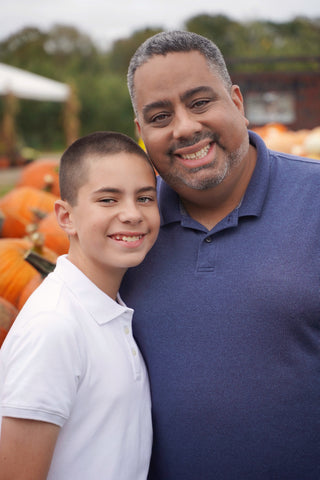 teenage son smiling with his father