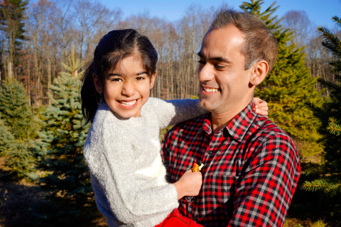 father holding smiling daughter