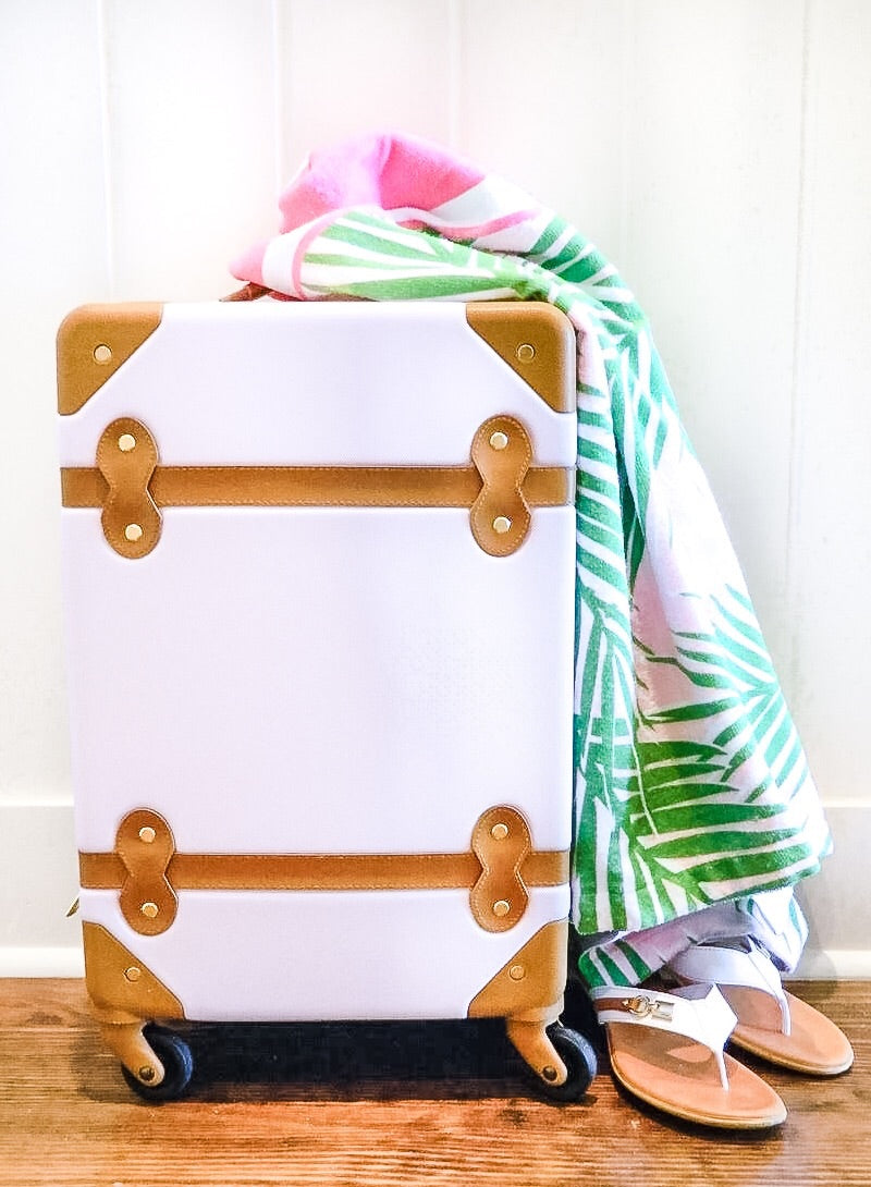 pink suitcase with personalized beach towel in preppy palm tree print