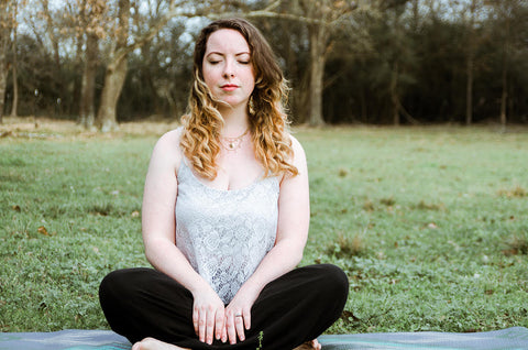 meditating girl writing blog post on locally grown