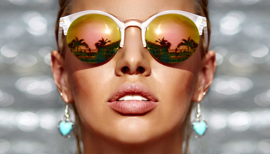 Get The Look: Summer Look 1 – Bronzing Close up of tan woman's face wearing reflective sunglasses, bronze makeup, and turquoise earrings  