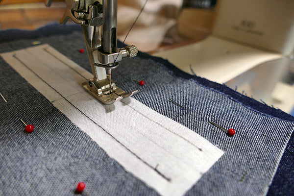 Sewing parallel horizontal lines of welt pocket.
