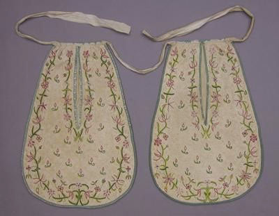 old fashioned pockets made of cream fabric and embroidered with flowers