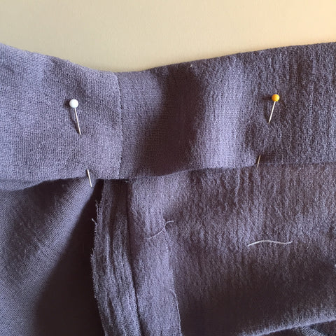 Edge stitch hem 1/8", easing around shoulder/neckline seam (again, stretching and sewing slowly to "ease" in the stitches so you have a shaped neckline).  You may want to increase your stitch length to 3 – 4 (or higher) for a smoother finis