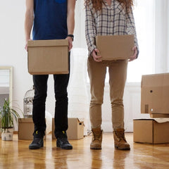 moving to las vegas couple moving holding boxes
