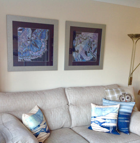 Pair of Deep Blue and Lilac paintings expertly hung above the sofa in Berkshire, England