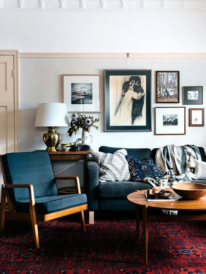 Living Room With Blue Sofa and Burgundy Rug