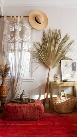 moroccan inspired home decor featuring a red rug, brass teapot and baskets for basket finds with La Basketry