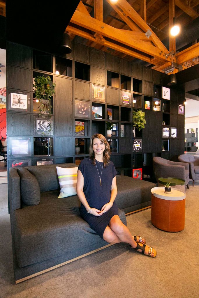 Mandy Riggar of Mandy Riggar Interiors sitting on a custom modular Division sectional from Perch Furniture that she designed for the Archrival Agency.