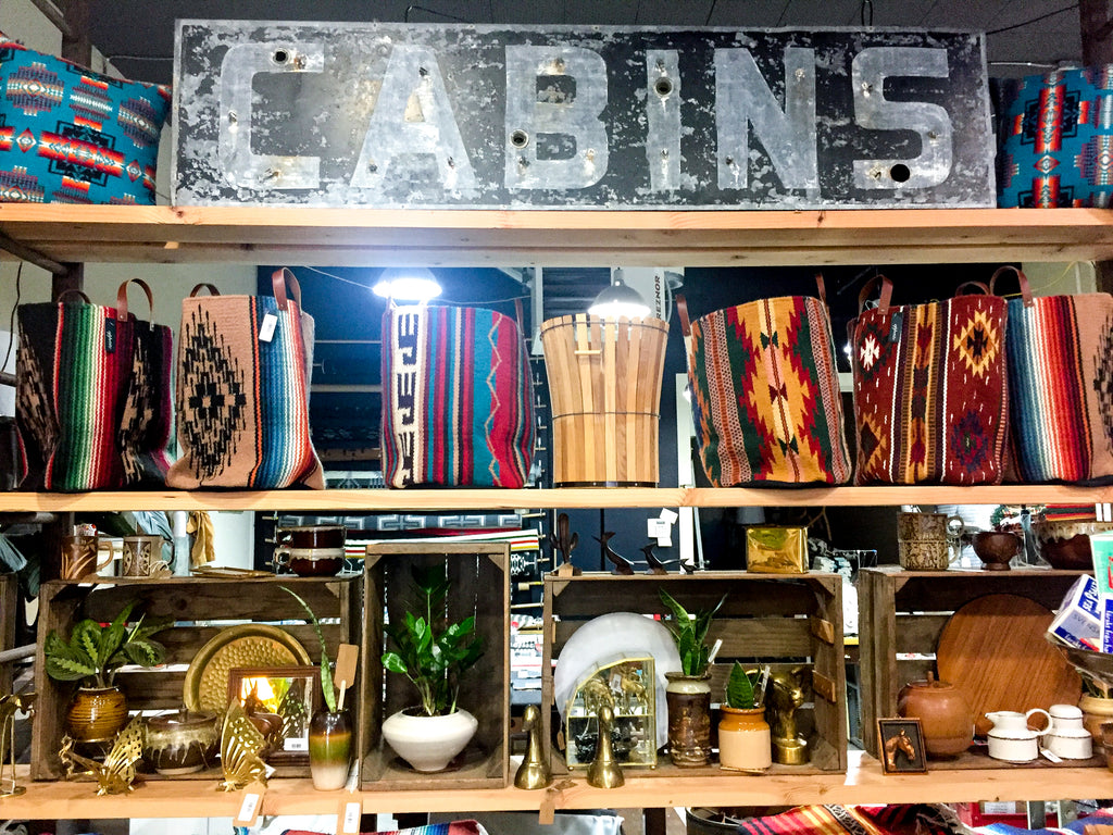 A wall of shelves divides the retail space from the workshop at Appetite Shop in Portland, Oregon