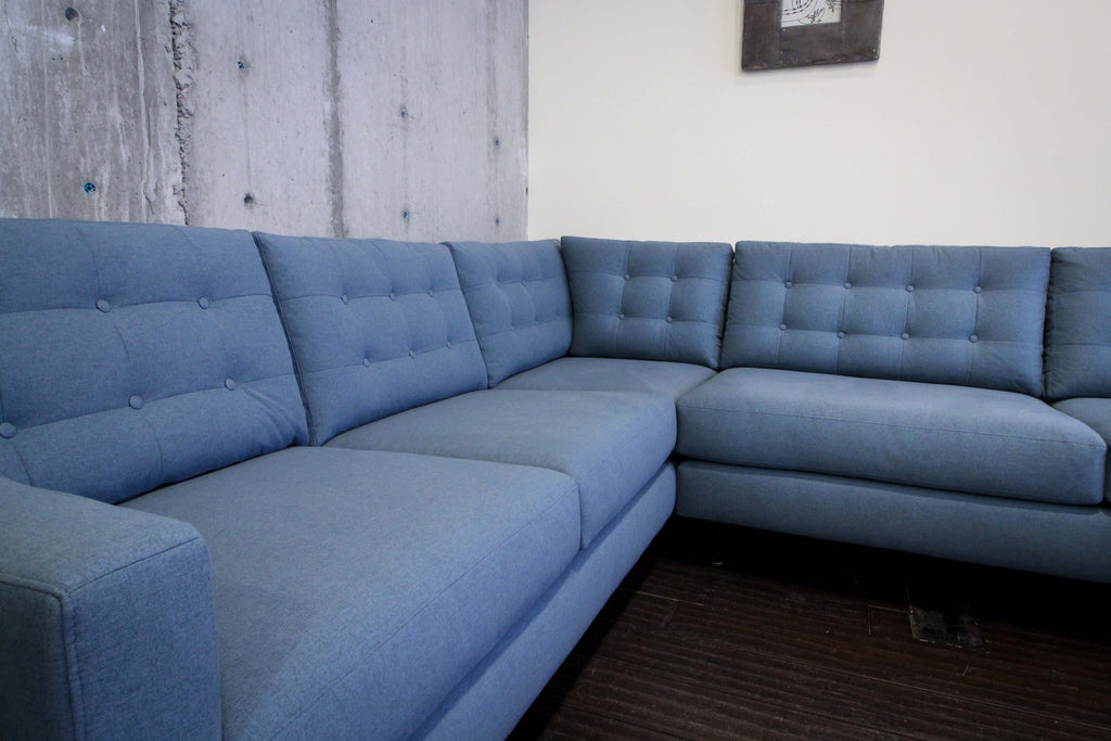 Tufted back cushions give the Quinn sectional a tailored look