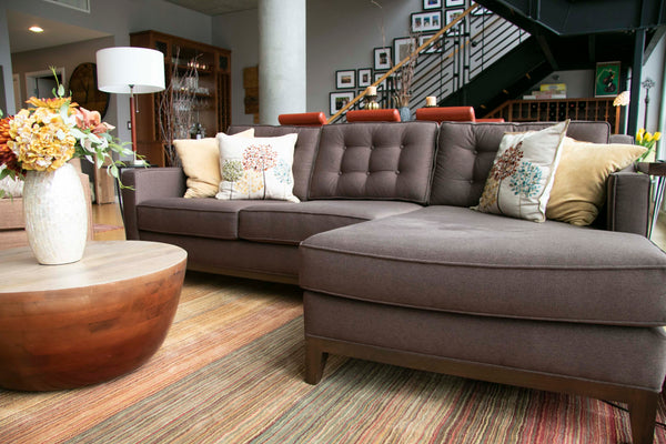 Lawson sofa chaise with buttons and a wooden base trim