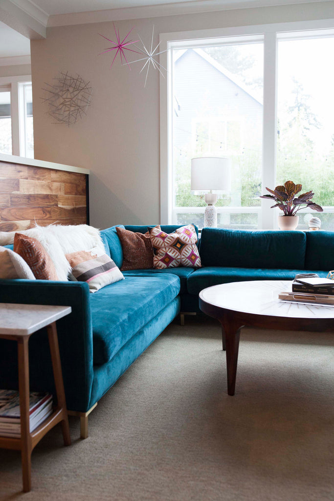 A teal blue velvet Charlie Sectional from Perch Furniture defines this family room.