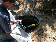 How to build a water garden pond - while the pond is filling, attach the liner to the Hydro Vortex waterfall filter.