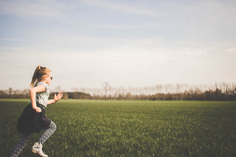 Little girl running in a field