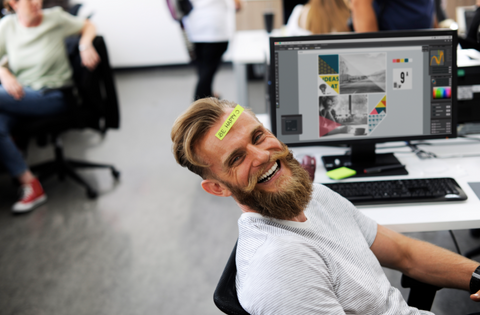 Man smiling while at his desk