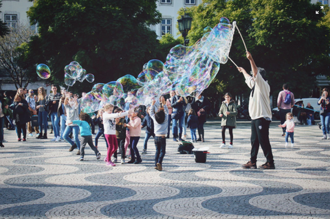 Children enjoying bubbles in a park